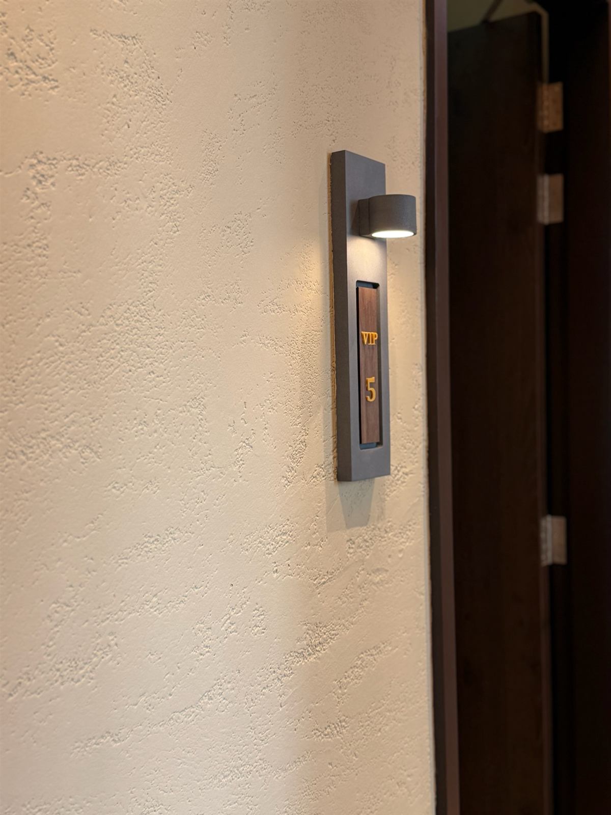 Pitted finish beside a room sign in a spa corridor