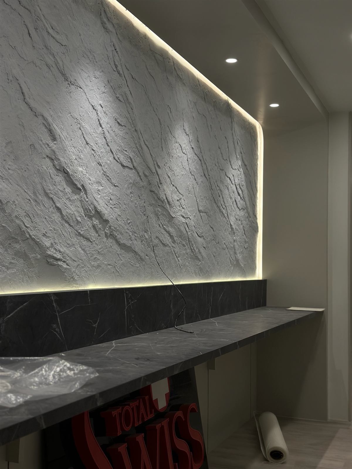 Stone Craft feature wall behind the counter at Total Swiss